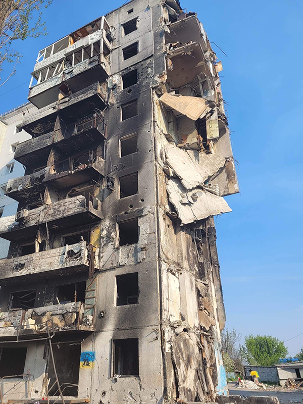 Photo: Even though it had been several weeks since the attack on Bucha, the scorch marks on the buildings, the fires that had burned were still evident. The citizens had done everything they could to clear the streets of the rubble and debris so that the officers and military could come in and deal with the scene -- the bodies, the women and the children. Some people still passionate about their country would make sure that they would know that this building was a Ukraine building, that it was the house for the residents, the people that lived there.