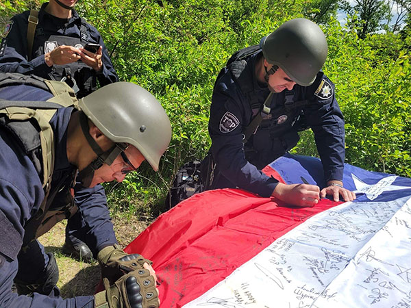 Being a Texan, I could not go to the Ukraine without taking a flag with me. I wanted every officer I met to know that we, Texas at least, knew what they were going through. And I wanted all of them to sign my flag, to put a message, to write their name, and I would bring it home with me so they would know they would not be forgotten.