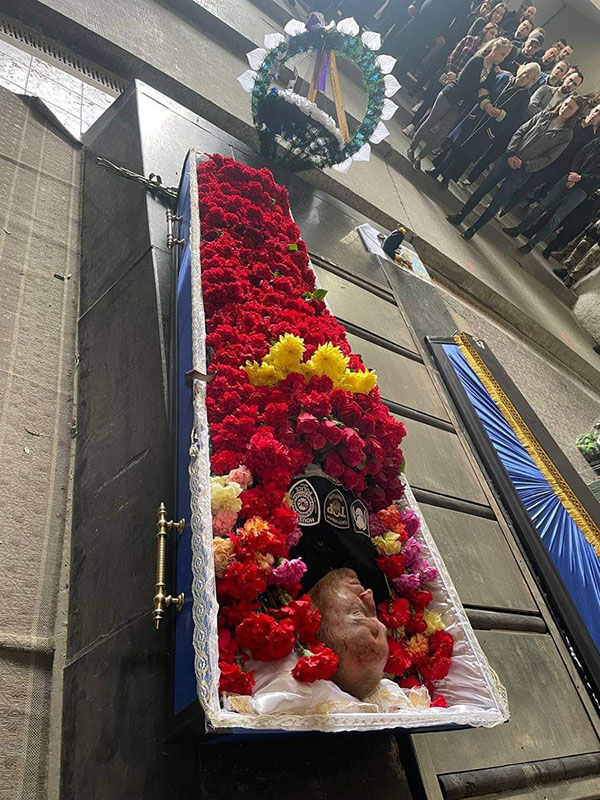 While in Kiev, I attended the officer's funeral who we retrieved from Nikolaev (Mykolaiv). The flowers in his coffin are there because every person who attended his funeral brought a single flower. And as each person would pass and give their respects to him, that flower would be placed in the coffin with him. The flowers leave an image of how much he was cared for and respected. The patches on his chest symbolized that he was a member of Tor which is a specialized unit in tactics and medical and crowd control. Myself and other officers helped start that unit and he was of mine, he was one of ours. When it was my turn and I passed him, then gave my flower to his casket, I wanted to be sure that what he had done and what we had done together would not be forgotten. I took the last patch I had from my unit, and I laid it on him, because he was one of us and I wanted everybody to know it.