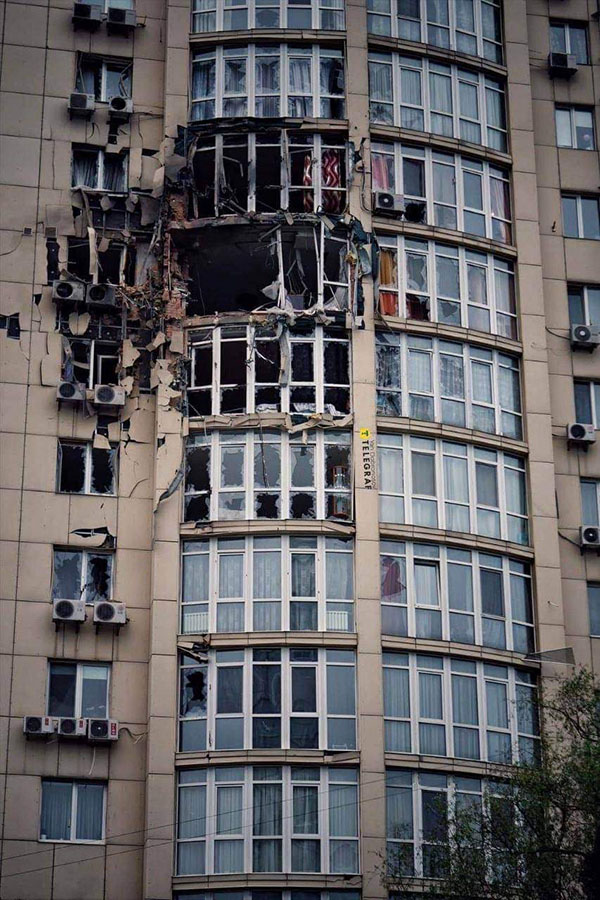 Bombed residential building and a shrapnel shelter to protect people