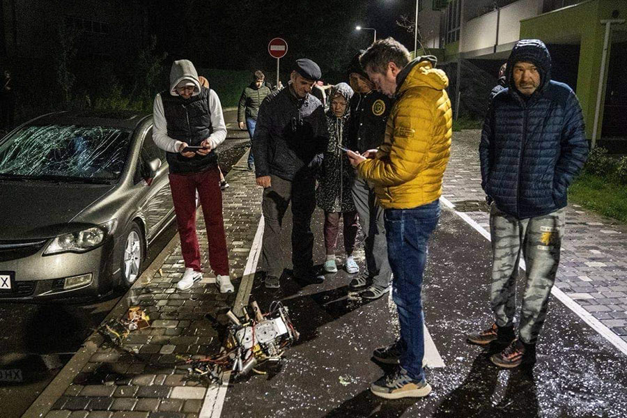 Photos of bombed out car and concerned Ukranian people